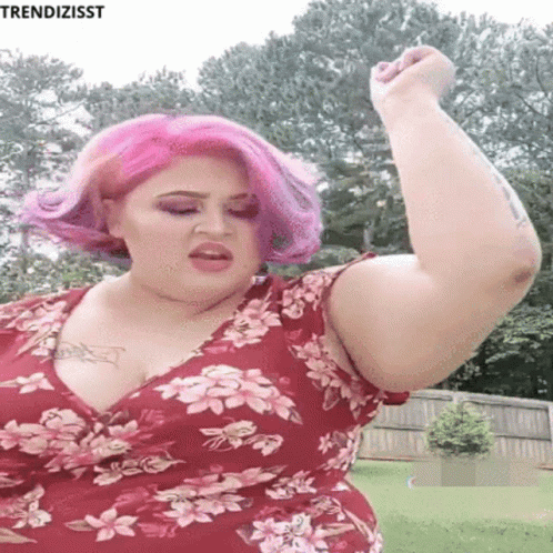 Woman With Pink Hair Flexing Muscles GIF