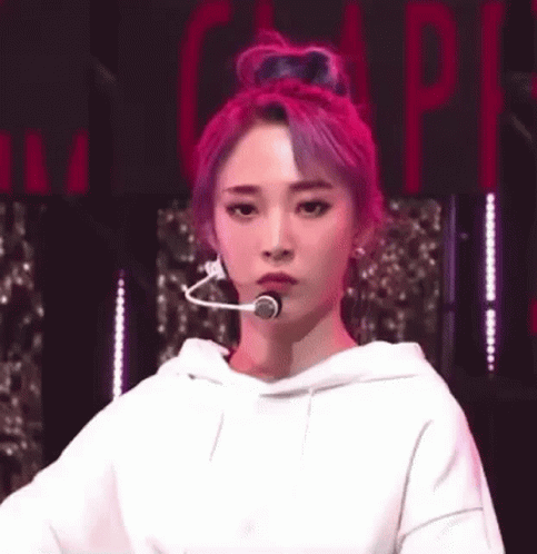 Woman with Pink Hair in White Hoodie and Head Microphone