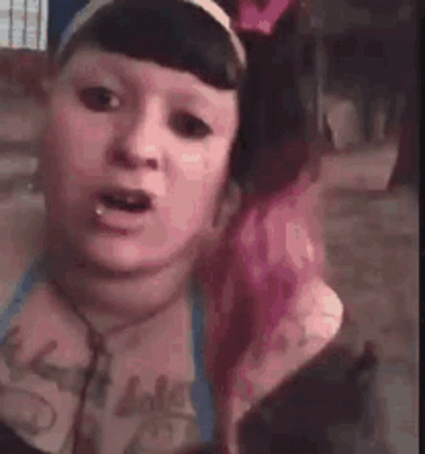 Woman With Pink Hair Making Funny Face Wearing Headphones and Headband