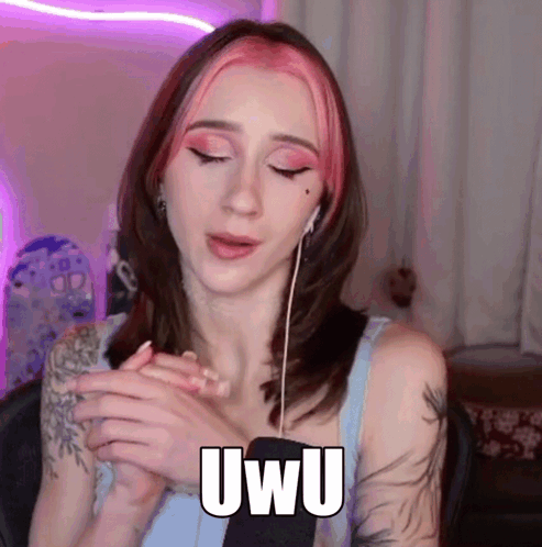 Woman With Pink Hair Wearing Ear Buds Saying Uwu