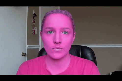 Woman with Pink Paint Sitting at Love Sign