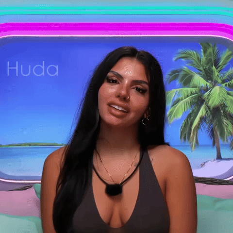 Woman With Plunging Neckline Smiling in Front of Palm Tree