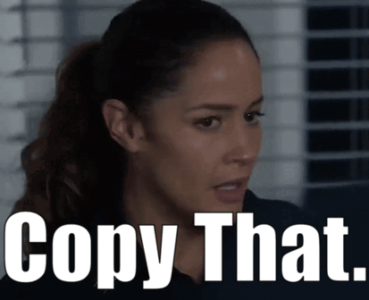 Woman With Ponytail Next to Copy That Sign