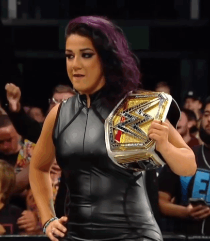 Woman With Purple Hair Holding Wrestling Championship Belt