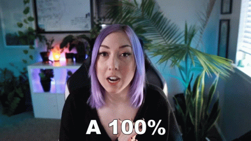 Woman With Purple Hair Saying A 100% In Front of Palm Tree