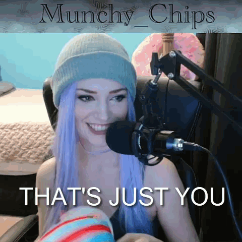 Woman with Purple Hair Smiling at Microphone