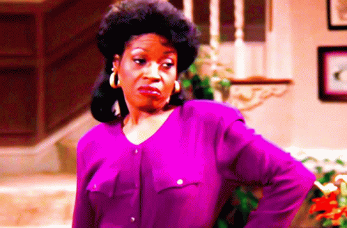 Woman With Purple Shirt And Hoop Earrings Funny Face GIF