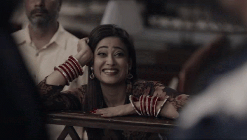 Woman With Red And White Bracelets Smiling GIF