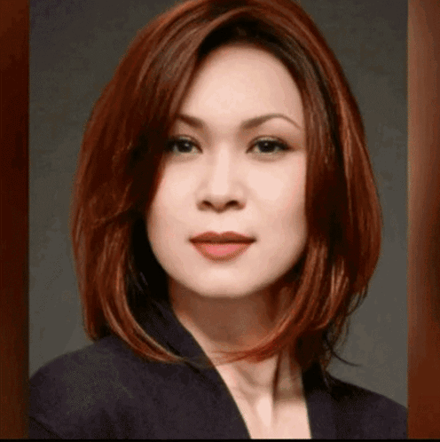 Woman With Red Hair And Black Jacket Looking At Camera GIF