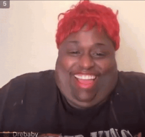 Woman With Red Hair and Black Shirt Smiling