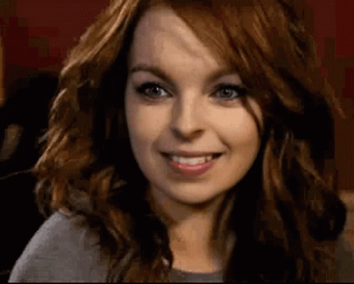 Woman With Red Hair And Blue Eyes Smiling GIF