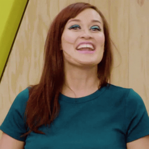 Woman with Red Hair and Blue Shirt Smiling