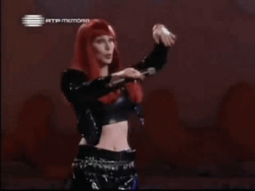 Woman with Red Hair and Crop Top in Front of Rtp Memoria Sign