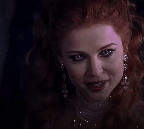 Woman With Red Hair And Earrings GIF