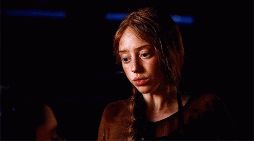 Woman With Red Hair and Freckles in Dark Room With Man