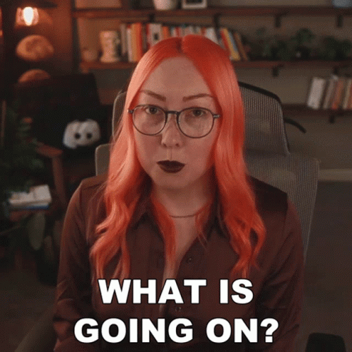 Woman with Red Hair and Glasses Asking What Is Going On