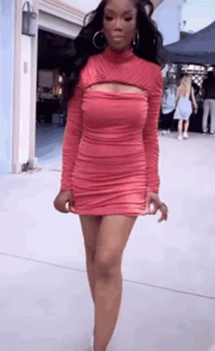 Woman With Red Hair And White Pants In Dark Room GIF