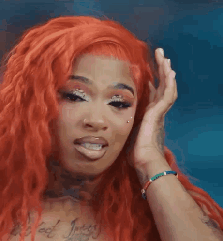 Woman With Red Hair Covering Ear GIF