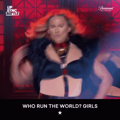 Woman with Red Hair Dancing Who Run The World Girls