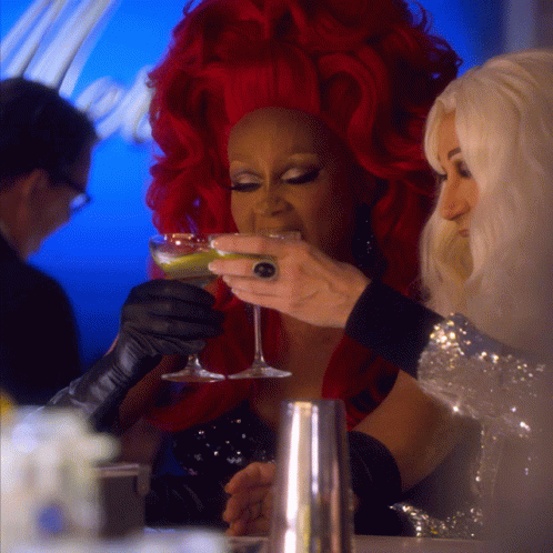 Woman With Red Hair Holding Champagne GIF
