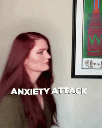 Woman With Red Hair In Front Of Anxiety Attack Sign GIF