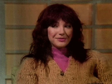Woman with Red Hair in Sweater and Pink Shirt
