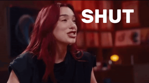 Woman with Red Hair Laughing at Shut Up Sign