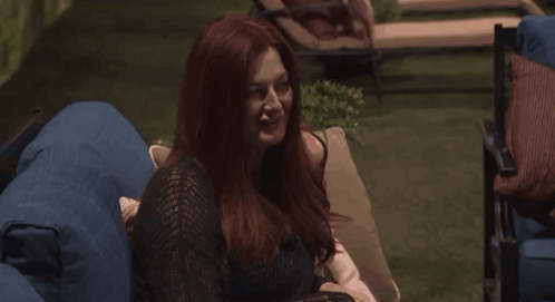 Woman With Red Hair Laughing on Blue Couch