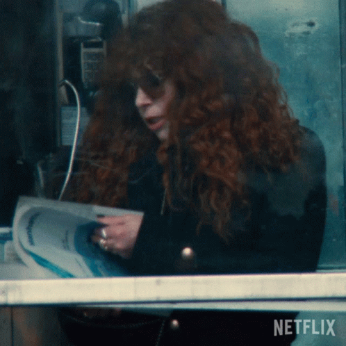 Woman with Red Hair Reading Newspaper