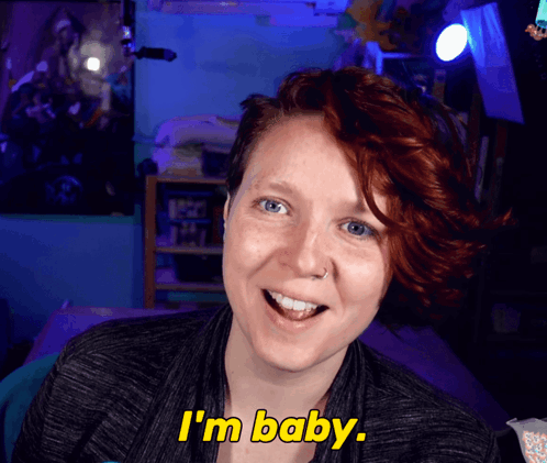 Woman With Red Hair Says I'm Baby in Yellow Letters