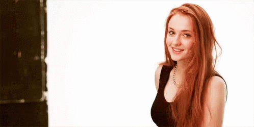Woman With Red Hair Smiling in Black Top
