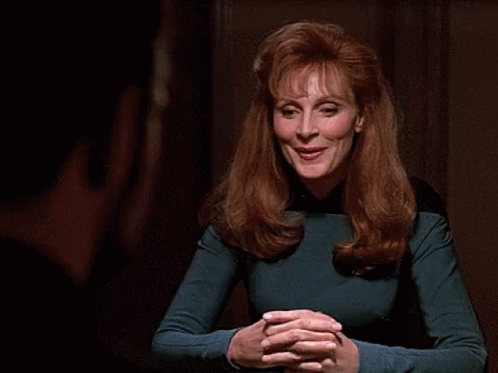Woman With Red Hair Smiling In Blue Top GIF