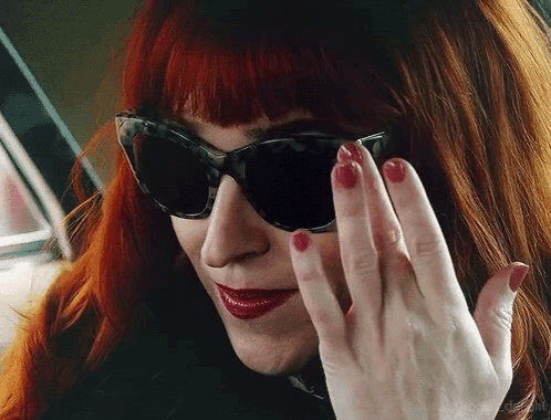Woman with Red Hair Sunglasses and Nails