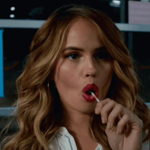 Woman With Red Lips Eating Lollipop