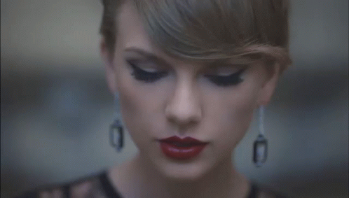 Woman With Red Lipstick and Black Earrings