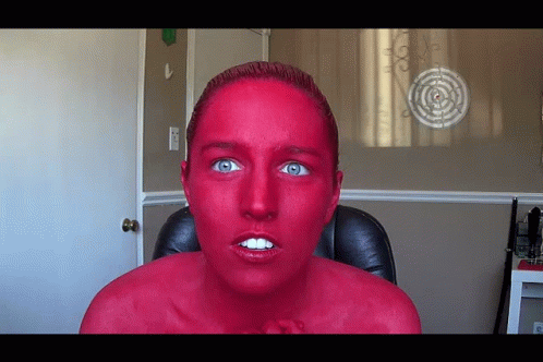 Woman with Red Paint Face Sitting Before Target