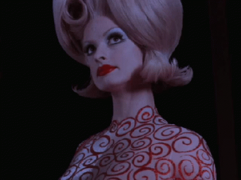 Woman With Red Swirls On Body And Hair GIF