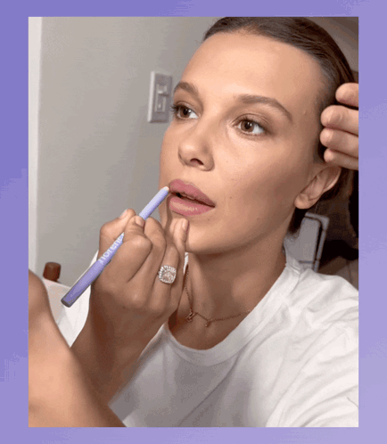 Woman With Ring Applying Lipstick