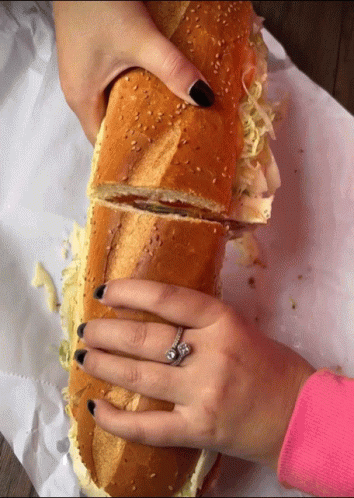Woman with Ring Holding Sandwich