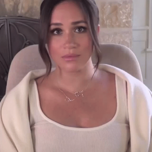 Woman With S Necklace Sitting in Chair