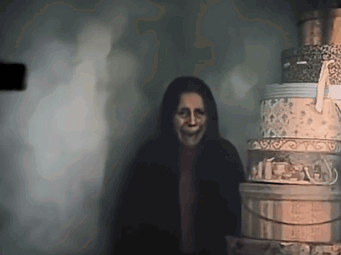 Woman With Scary Face Next to Stack of Boxes
