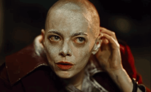 Woman With Shaved Head and Red Jacket