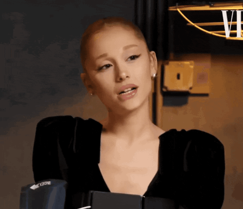 Woman With Shaved Head Wearing Black Vogue Top