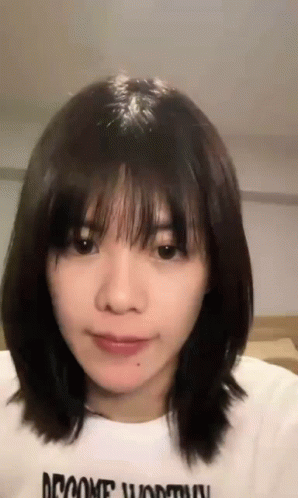 Woman with Short Hair and Bangs in White Shirt