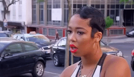 Woman With Short Hair And Red Lipstick In Parking Lot GIF