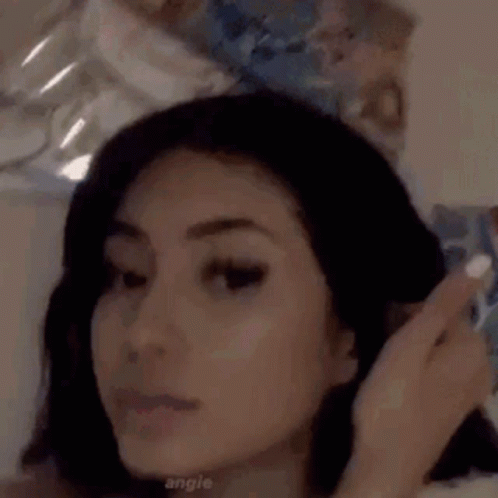 Woman With Short Hair Taking Selfie in Front of Mirror