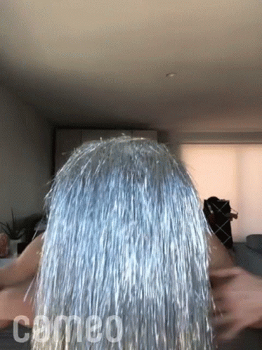 Woman With Silver Tinsel Hair And Comeo GIF