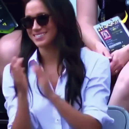 Woman with Sunglasses and White Shirt Smiling Clapping