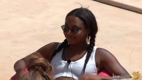 Woman With Sunglasses And White Tank Top On Love Island Float GIF
