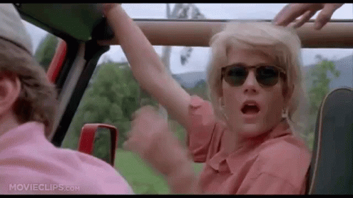 Woman with Sunglasses Arm Outstretched in Car